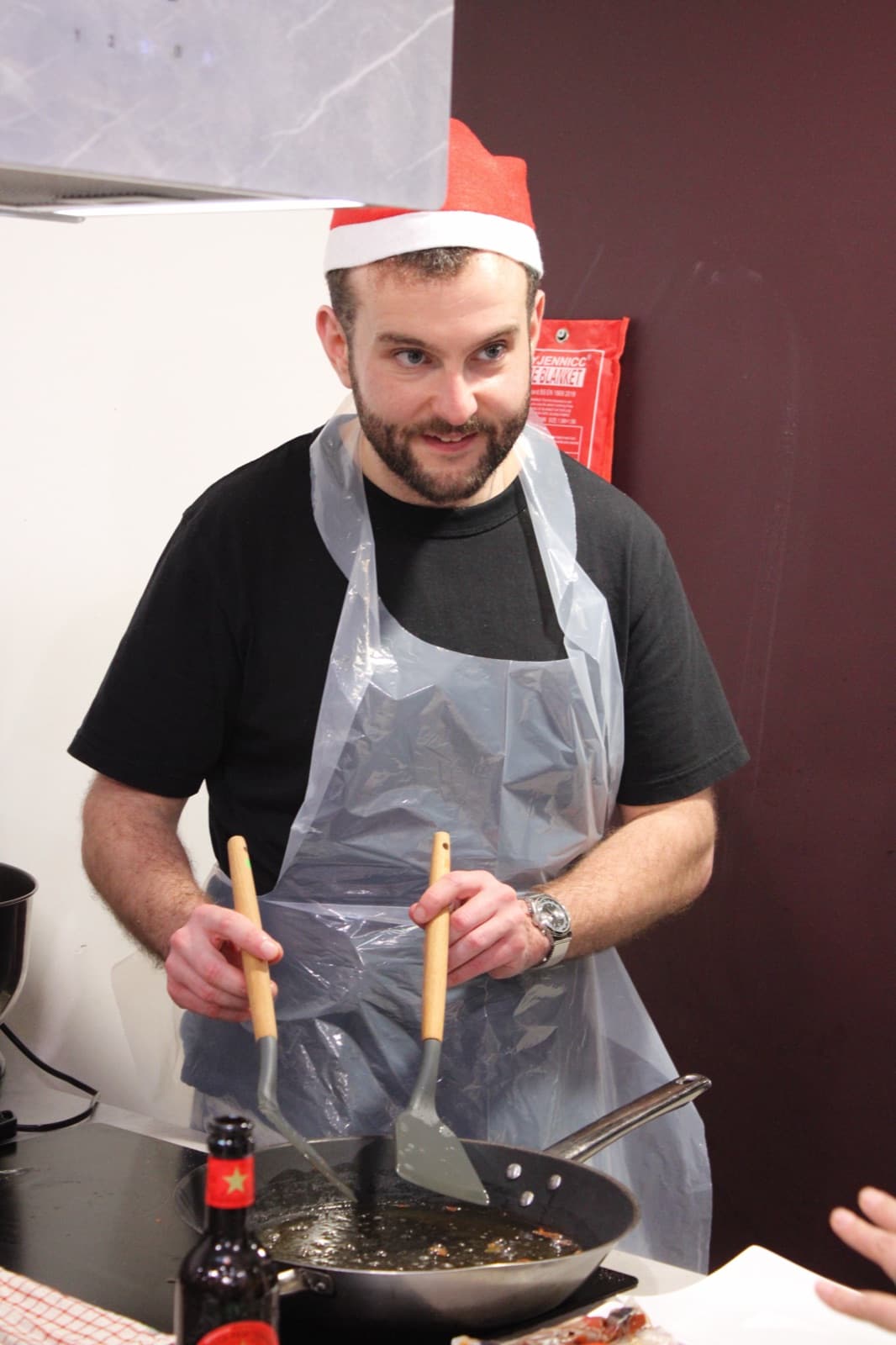 A stag party cooking against each other at the battle bench at Cooking It in Bristol