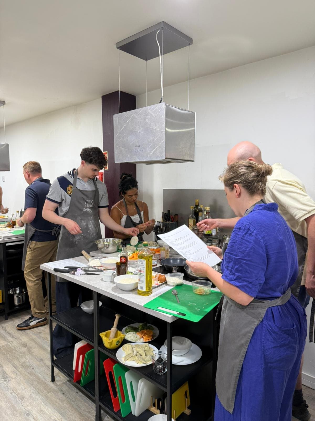 A team cooking together at the prep table at Cooking It in Bristol